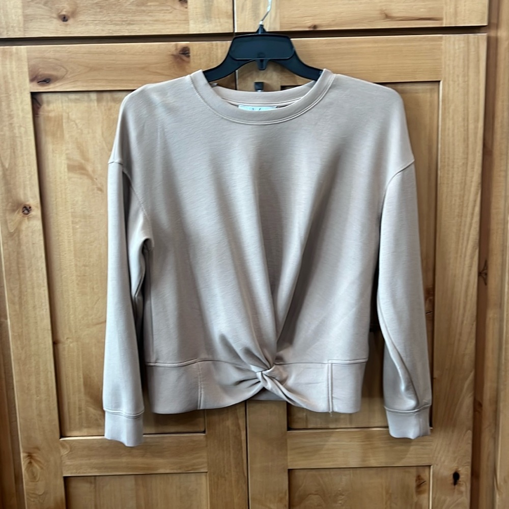 Extremely soft sweatshirt with knotted feature at waist.
